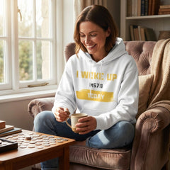 Woman sitting on a couch holding a mug, wearing a hoodie with text, in a cozy living room.